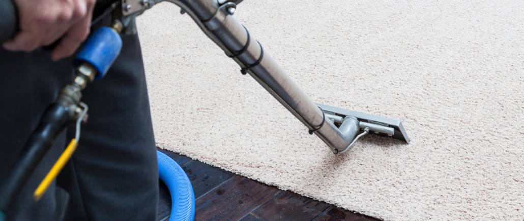 carpet cleaner cleaning carpet with a wand